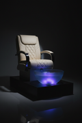 LUMINOUS pedicure chair with AURORA LED bowl glowing in blue-purple spectrum against dark background