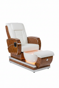 LIBERTÉ pedicure chair in white colorway with AURORA LED bowl glowing warm amber, burlwood and chrome accents visible