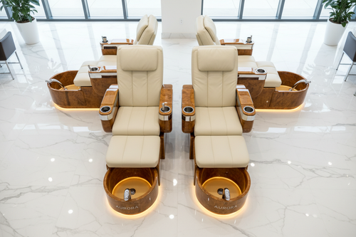 Four PRIVÉ Lounge chairs fully reclined in synchronized position on white marble floor, AURORA bowls glowing warm gold, overhead 45-degree view